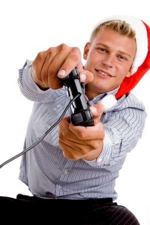 young man with christmas hat and remote on an isolated background