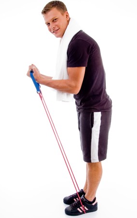 healthy man stretching with exercise rope against white background