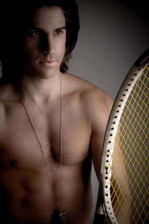front view of shirtless man holding racket on an isolated backgroundの写真素材