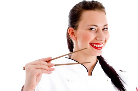 female chef holding chopsticks on an isolated white backgroundの写真素材