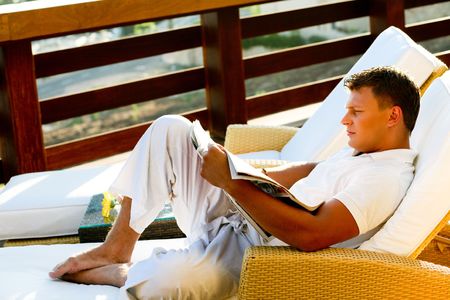 Male busy reading a bookの写真素材