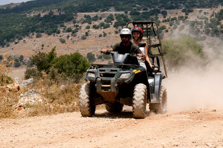 A four-wheeler ATV runs through trail on sunny dayの写真素材