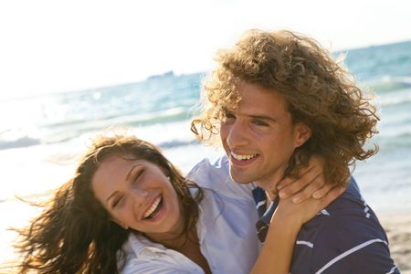 Beautiful young woman in a playful mood with her boyfriendの写真素材