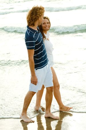 Affectionate hispanic couple walking by the seaの写真素材