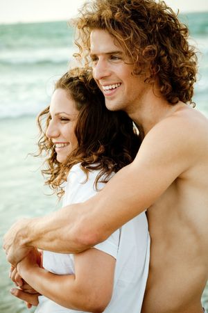Man and woman lazing near the beach and smilingの写真素材