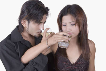 Close-up of a young couple drinking white wineの写真素材