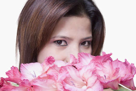 Portrait of a young woman with flowersの写真素材