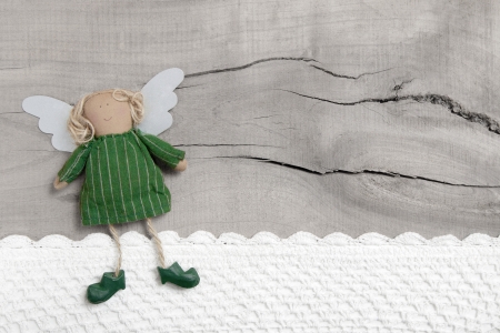 Top view of angel with crochet strip on wooden backgroundの写真素材