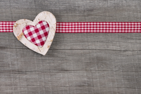 Top view of checked heart decoration on wooden tableの写真素材