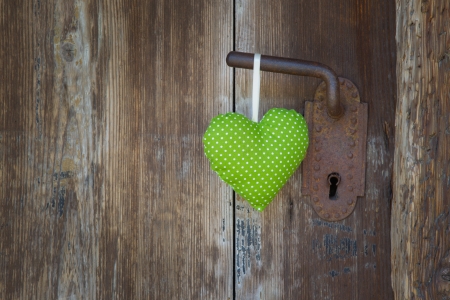 Green heart shape hanging on door handleの写真素材
