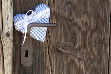Checkered heart shape hanging on door handleの写真素材