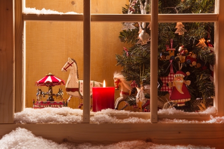 Atmospheric christmas window with old rocking horsesの写真素材