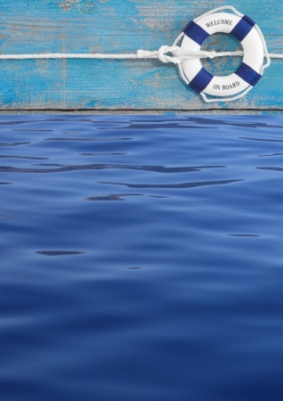 Blue lifebuoy on turquoise ship and water for maritime decoration or background for teamworkの写真素材