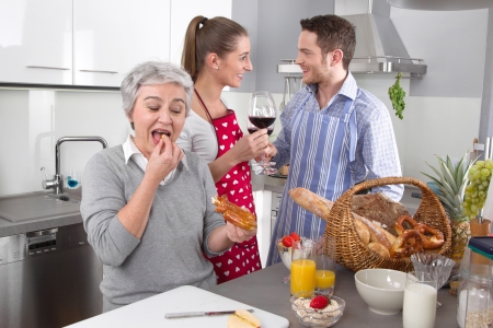 Happy family cooking together - with the grandmotherの写真素材