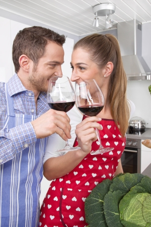 Couple in love cooking together in the kitchen and have funの写真素材