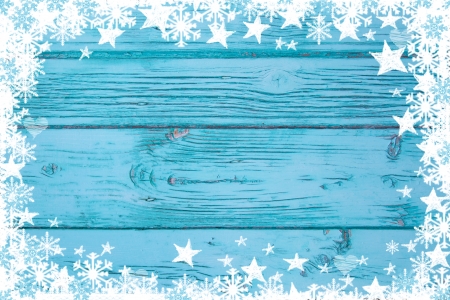 Blue or turquoise wood background for advertising or a greeting card with stars and snowflakesの写真素材