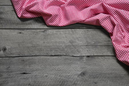 Checkered fabric as border on grey wooden background for christmas, birthday, valentineの写真素材