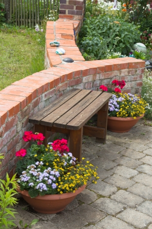 Bench and flowers in the garden - outside.の写真素材