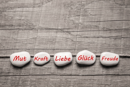 Stones with german words for love on wooden background for birthday or valentines day.の写真素材