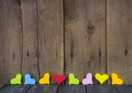 Wooden background with hearts for valentine, birthday or friendship.の写真素材