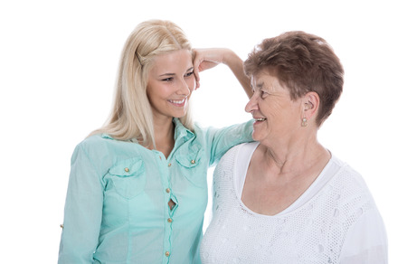 Isolated portrait of real grandmother with her granddaughter. Happy family life.の写真素材
