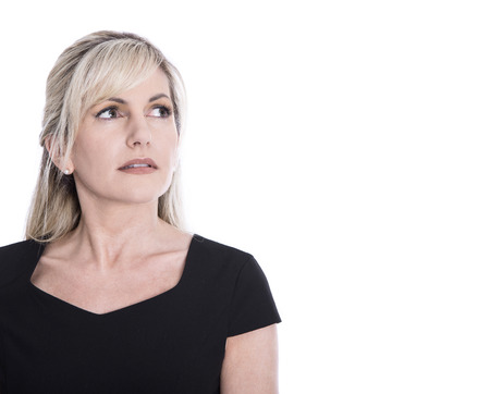 Portrait of isolated mature businesswoman face looking sorrowful and pensive.の写真素材
