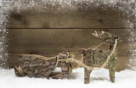 Handmade elk or reindeer with slide of wood on wooden background.Hobby creative.の写真素材