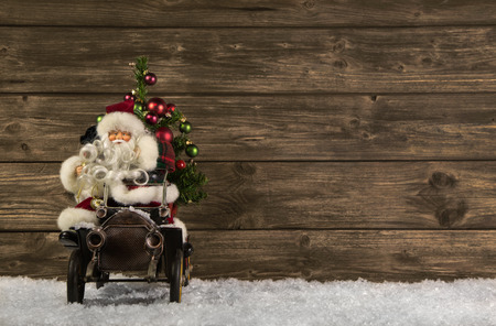 Santa Claus: Vintage christmas decoration on wooden brown background.