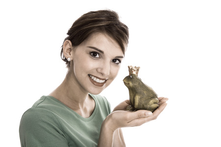 Story of frog king - young isolated woman. Concept for singles, wedding or valentine's day.の写真素材