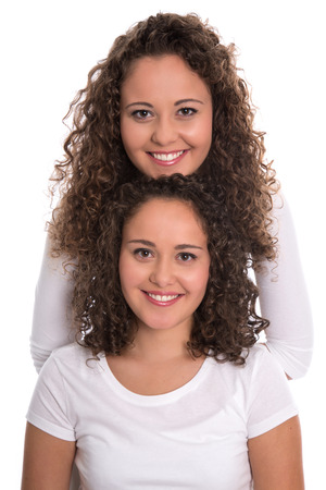 Real monozygotic twins with natural stop curls isolated over white background.の写真素材
