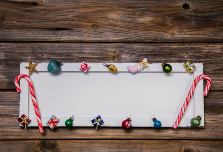 Colorful wooden white christmas card, frame or background with decoration.の写真素材