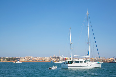 Sail boats in the port of Siracuse in Sicilia, City Ortygiaの写真素材