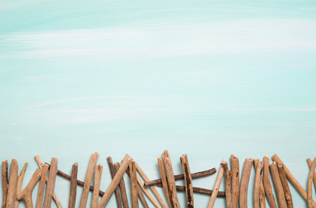 Blue or turquoise oceanic background with a fence of driftwood. Maritime items.の写真素材