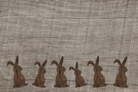 Old wooden background with an easter bunny for decoratios.の写真素材