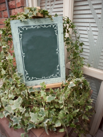 Empty Green Chalkboard surrounded by decorations の写真素材