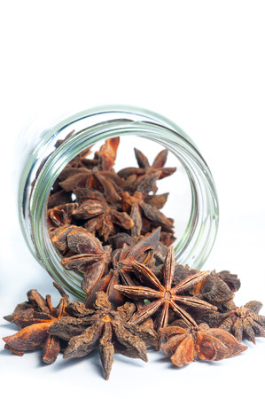 Star Anise come out from a jar on a white background; isolatedの写真素材