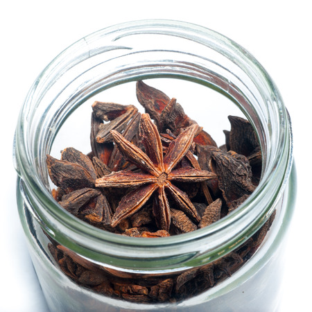Star Anise in a jar isolated on a white backgroundの写真素材