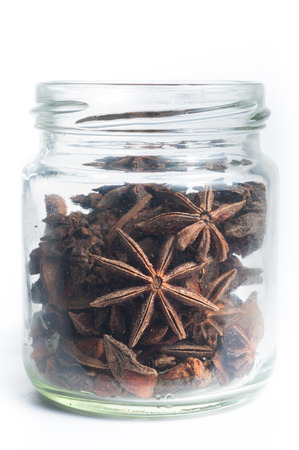 Star Anise in a jar isolated on a white backgroundの写真素材