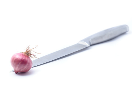 Shallots, Raw and uncooked on a knife isolated on white background