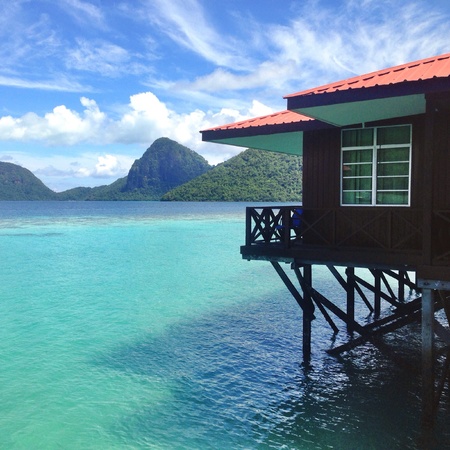 A house on clear sea water on an islandの素材