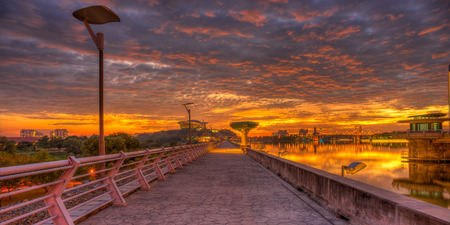Fiery sunset at a dam - panoramic formatの写真素材