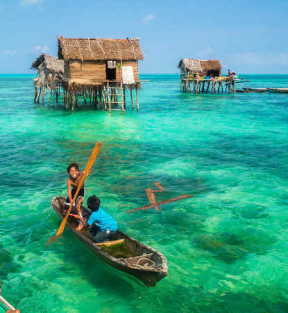 Sea Gypsy Kids on their sampan at their house on stiltsのeditorial素材