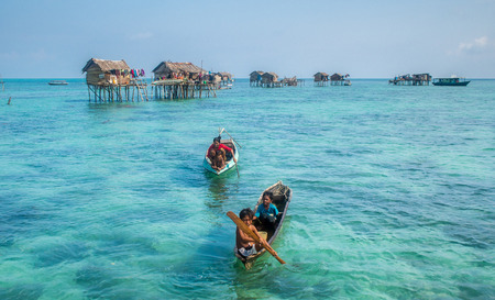 Sea Gypsy Kids on their sampan at their house on stiltsのeditorial素材