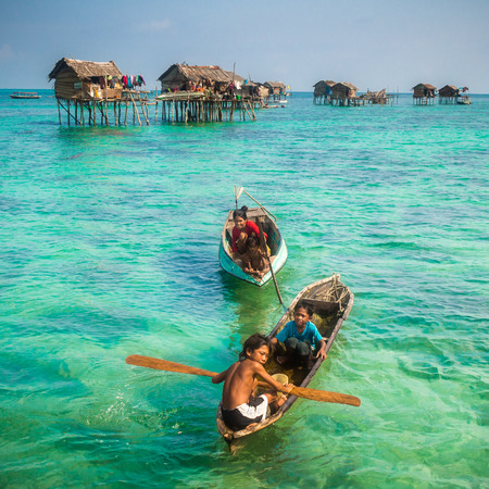 Sea Gypsy Kids on their sampan at their house on stiltsのeditorial素材