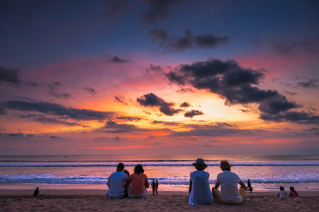 Tourist viewing sunset at Kuta Beach, Bali.の写真素材
