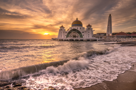 Sunset at a mosque by the seaの写真素材