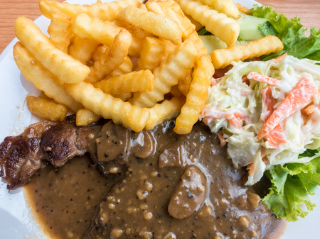 Lamb chop, fries and coleslawの写真素材