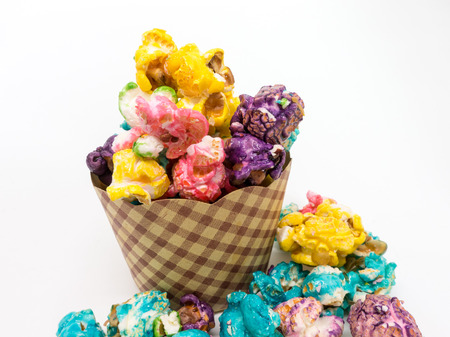 Isolated - Colorful Popcorn in a paper cup on white background. Shallow depth of field.の写真素材