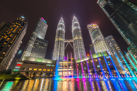 Tourists watching Colorful Water Fountain Show in front of the KLCC Petronas Towers, the tallest...