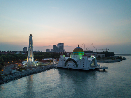 Aerial Photo - Dawn at The Melaka Straits Mosque, located on the man-made Malacca Island near Melaka City, Melaka, Malaysia.のeditorial素材
